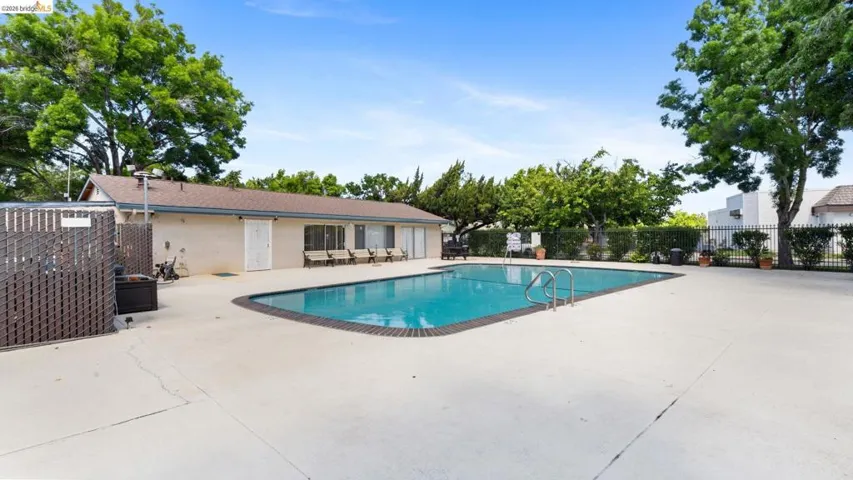 Community pool featuring a patio area