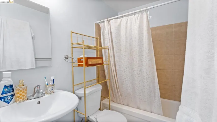Full bath featuring shower / tub combo and a sink