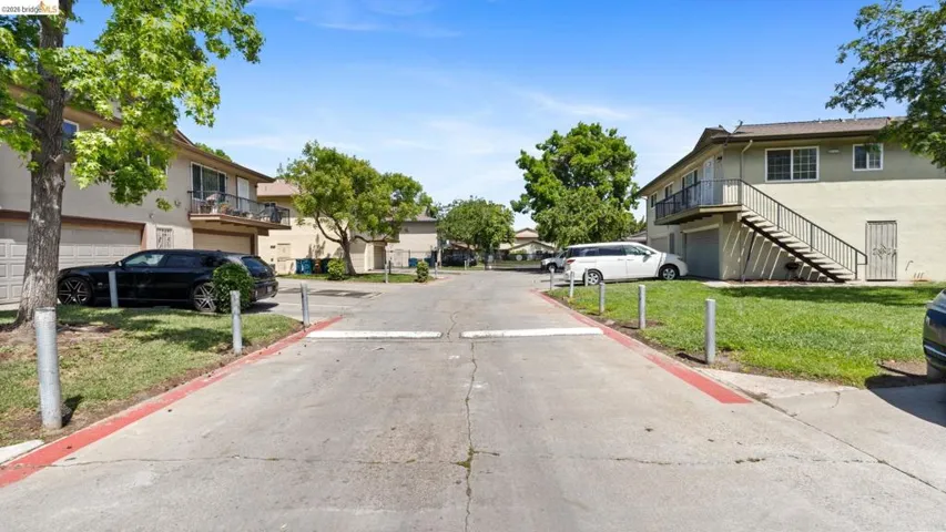 View of concrete road featuring a residential view and stairway