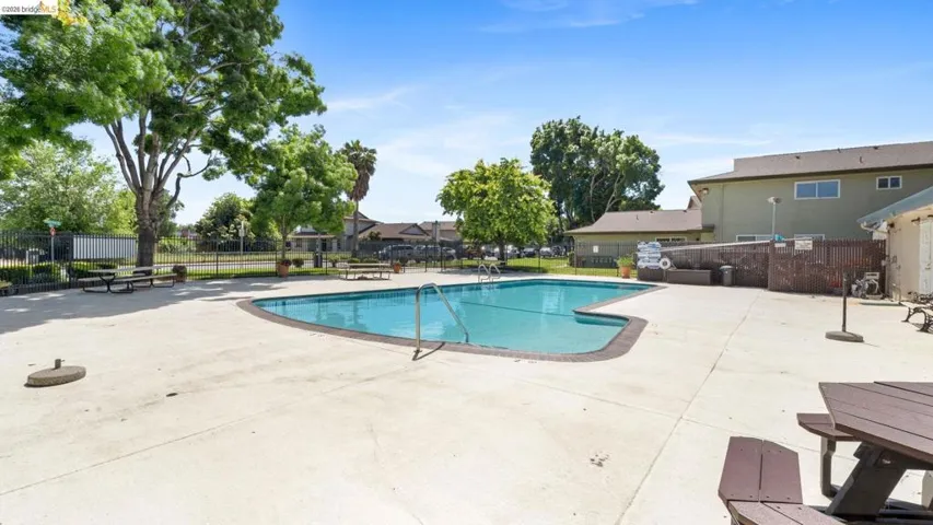 Community pool featuring a patio