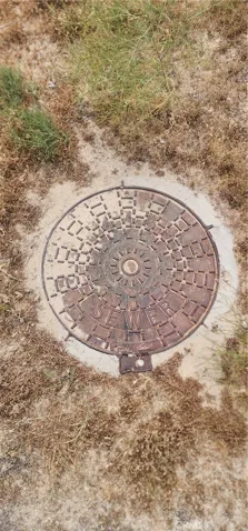 sewer access located on unpaved road