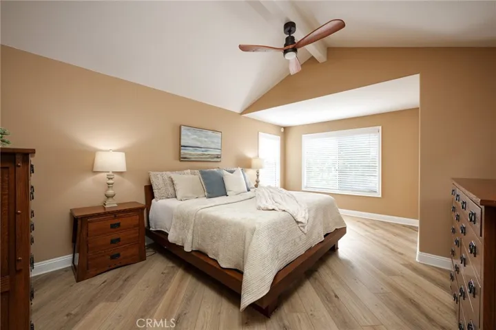 The spacious primary bedroom includes fresh paint, a vaulted ceiling, plantation shutters, and a large walk-in closet.