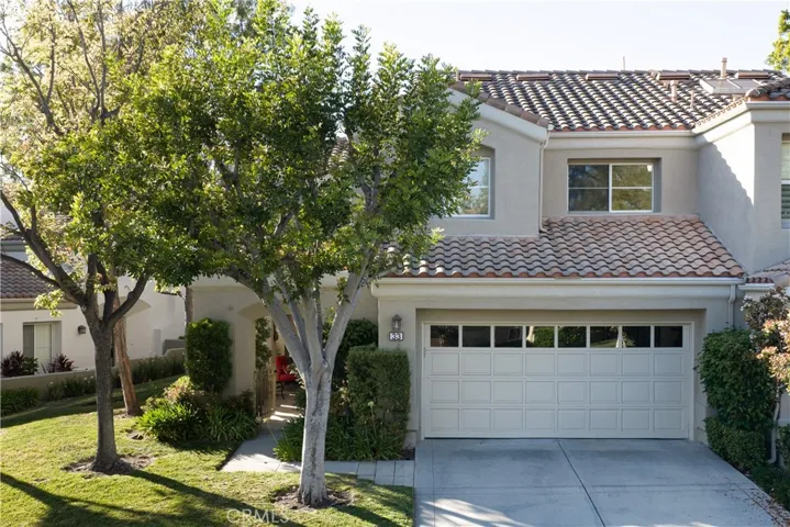 The home features a two car attached garage with a driveway.