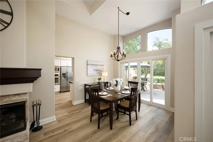 The dining room features a vaulted ceiling and plantation shutters.
