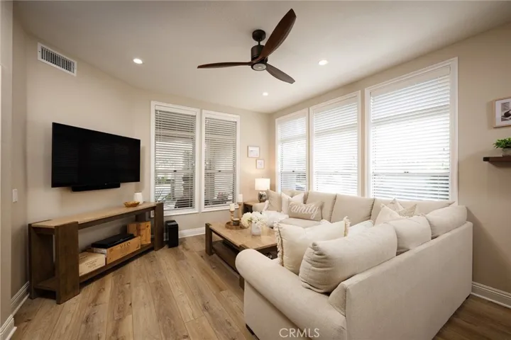 The family room features abundant windows,  fresh paint, and beautiful vinyl flooring.