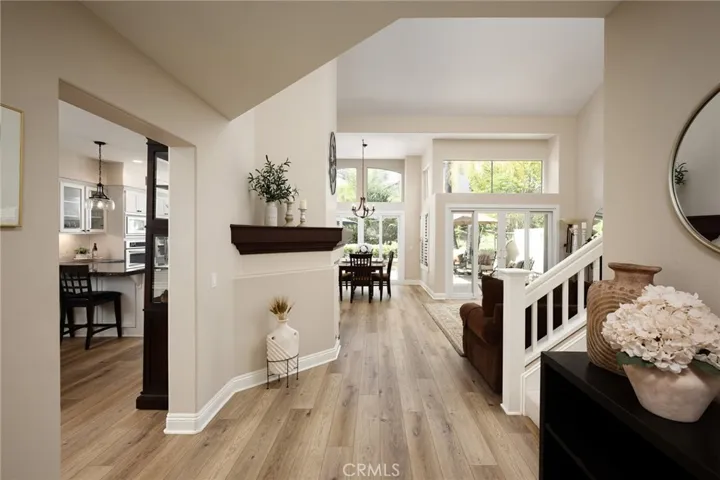 This stunning home features a dramatic front entry, vaulted ceilings, fresh paint, large baseboards, beautiful vinyl flooring, and updated lighting.