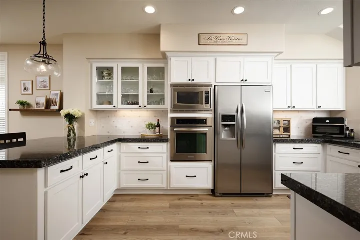 The impressive kitchen offers painted cabinetry and stainless steel appliances.