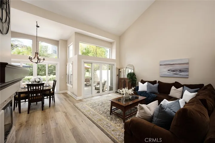The living and dining rooms showcase vaulted ceilings and plantation shutters.