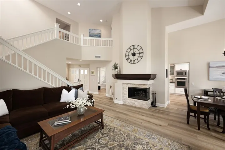 There is a striking fireplace with custom tile and mantle in the living room.