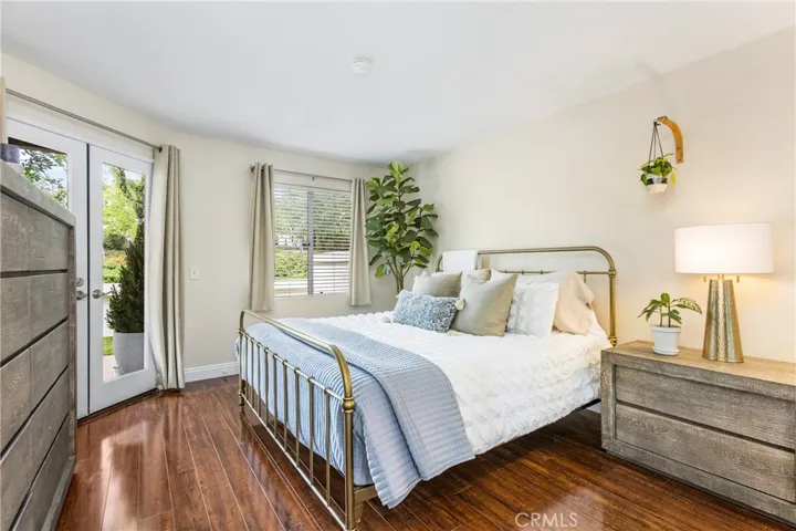 Primary suite with double French doors opens to the backyard