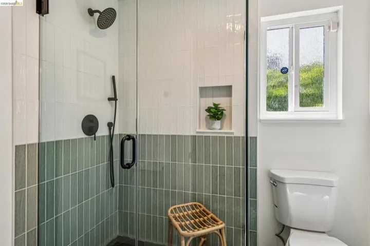 Full bathroom with a shower stall and toilet