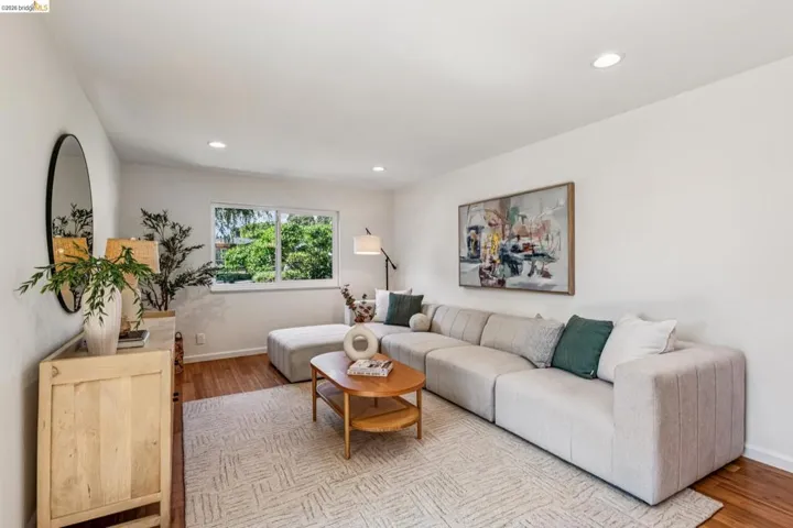 Living area with light wood-style floors and recessed lighting