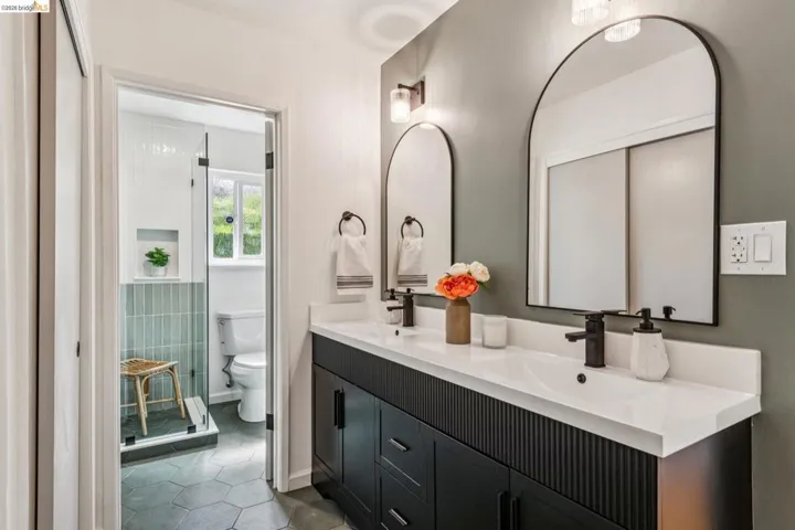 Bathroom with double vanity and light tile patterned floors