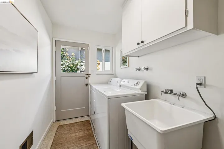 Laundry area with cabinet space and washing machine and clothes dryer