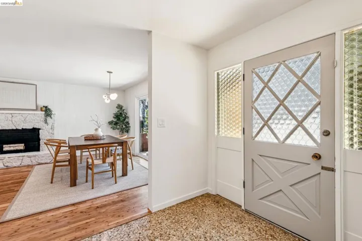 Foyer with baseboards and a stone fireplace