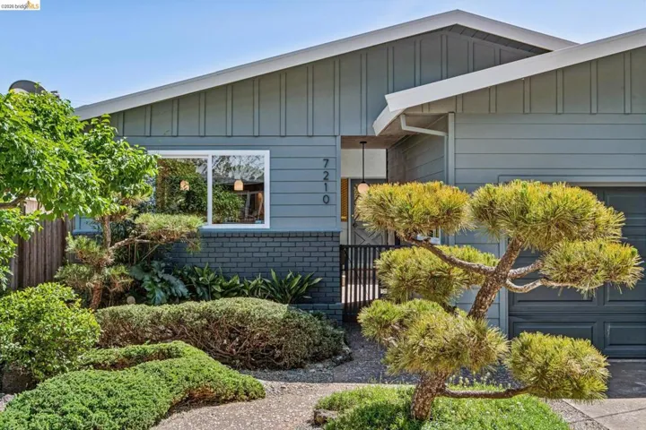 View of home's exterior featuring board and batten siding and brick siding
