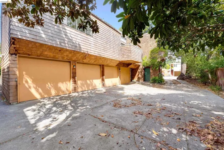 View of home's exterior with driveway, brick siding, and an attached garage