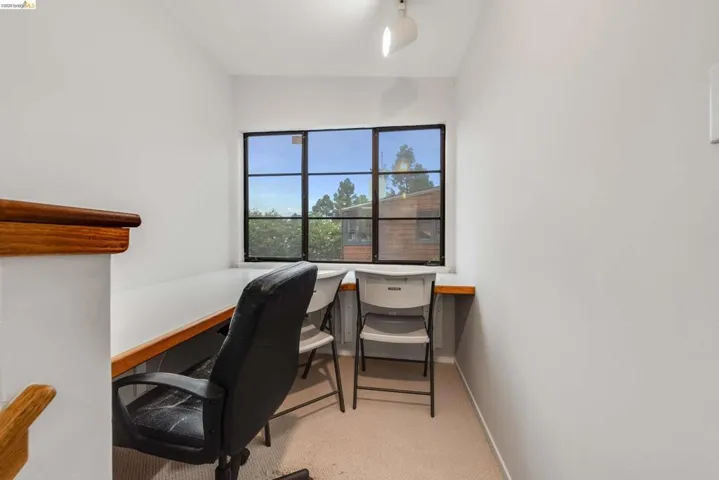 Office with light carpet and built in desk