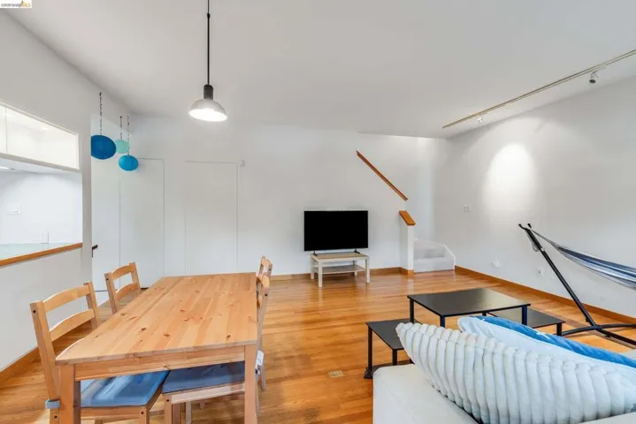 Living room with track lighting and wood finished floors