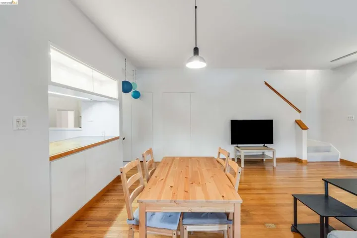 Dining room featuring light wood-style flooring and stairs