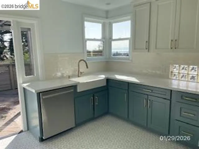Kitchen featuring stainless steel dishwasher and a sink