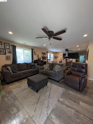 Living area featuring wood finished floors, recessed lighting, and ceiling fan