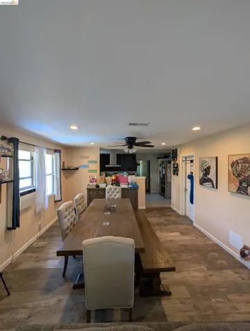 Dining room with dark wood-style flooring, a ceiling fan, and recessed lighting