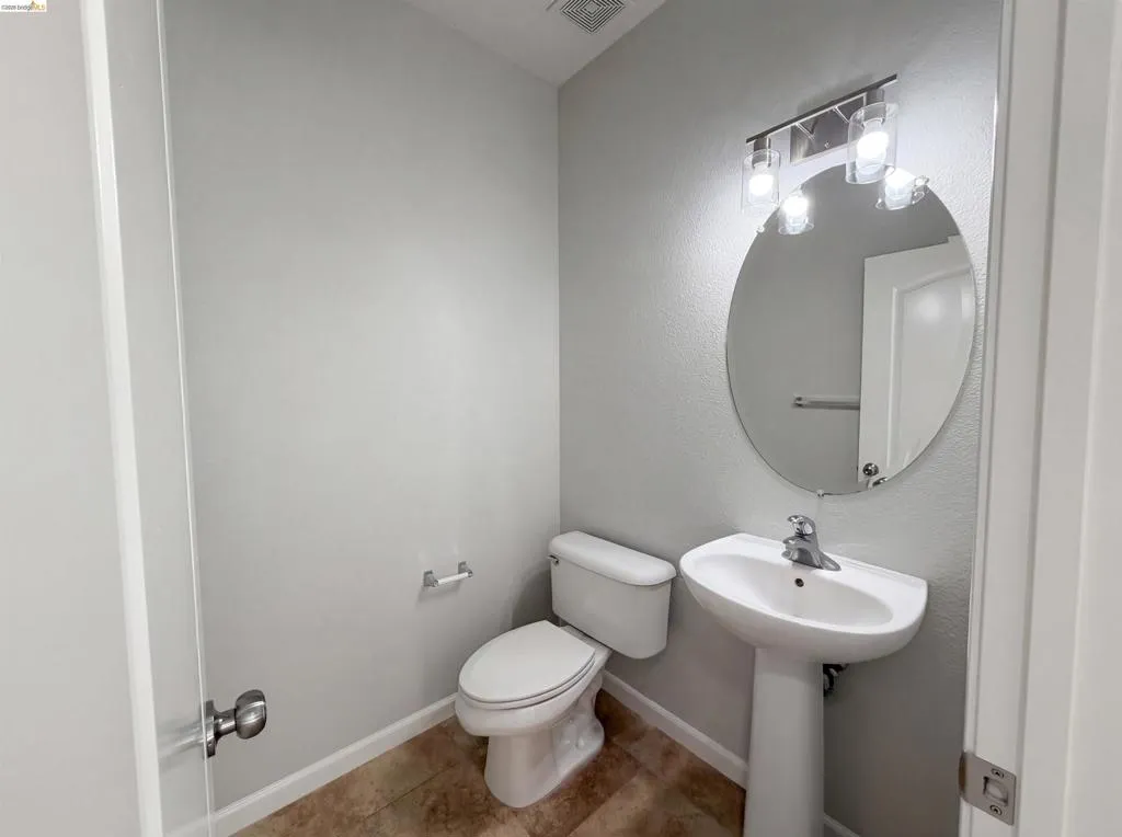 Bathroom featuring toilet and baseboards