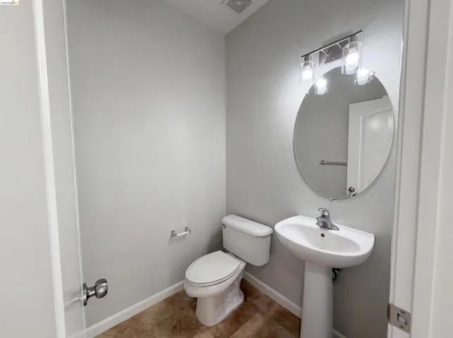 Bathroom featuring toilet and baseboards