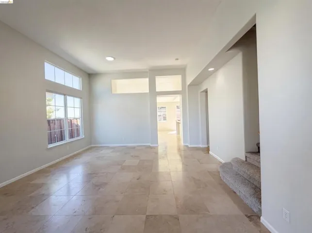 Spare room featuring baseboards and recessed lighting