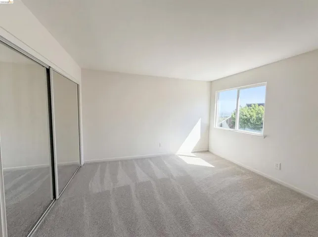 Unfurnished bedroom with a closet and light carpet