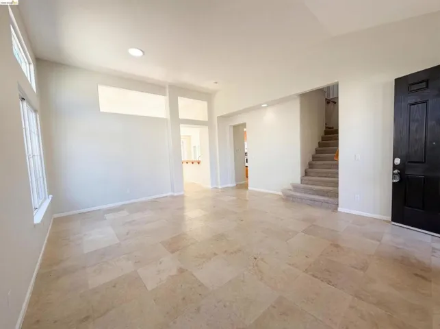Spare room featuring stairway and recessed lighting