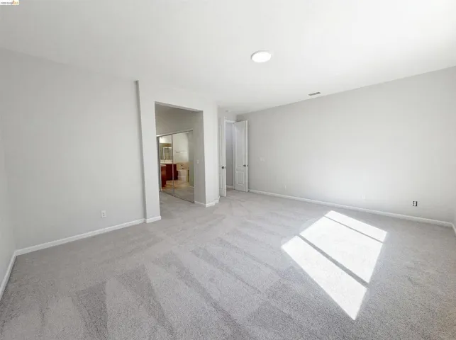 Unfurnished bedroom featuring a closet and light carpet