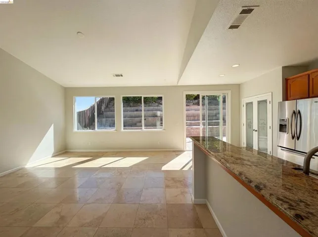 Unfurnished living room featuring a textured ceiling and recessed lighting