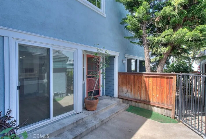 Gated courtyard entry, there is a French door to main entry as well as sliding doors on the left hand side that lead directly to the kitchen.