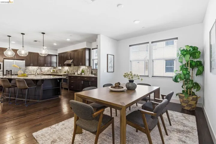 Dining area featuring dark wood-style flooring and recessed lighting