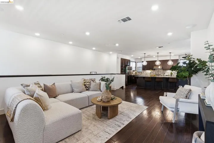 Living area with recessed lighting and dark wood finished floors