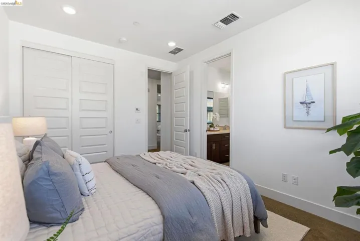 Bedroom featuring a closet, connected bathroom, recessed lighting, and carpet floors
