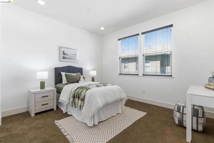 Bedroom with dark colored carpet and recessed lighting
