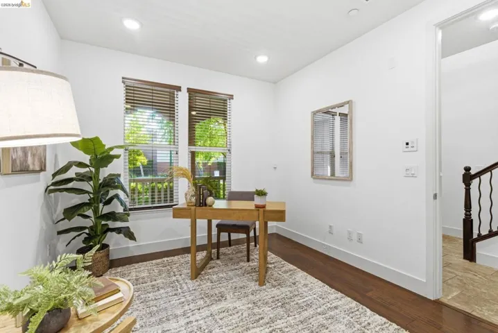 Office space with wood finished floors and recessed lighting