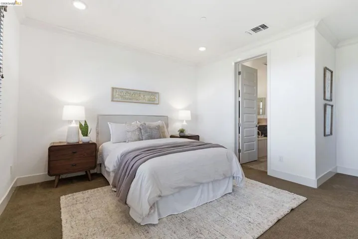 Bedroom with crown molding, dark carpet, recessed lighting, and ensuite bathroom
