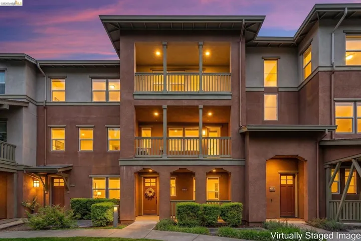 View of front facade with stucco siding and a balcony
