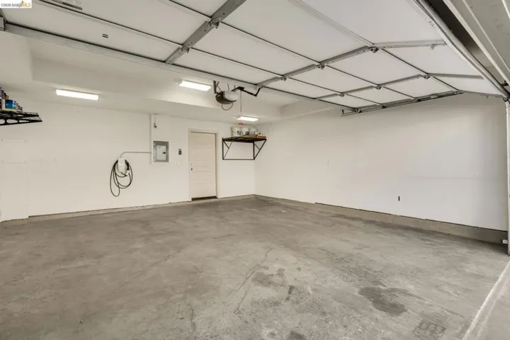 Garage featuring car charger and electric panel