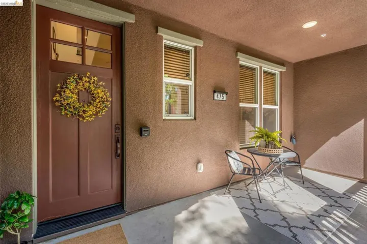 Doorway to property featuring stucco siding