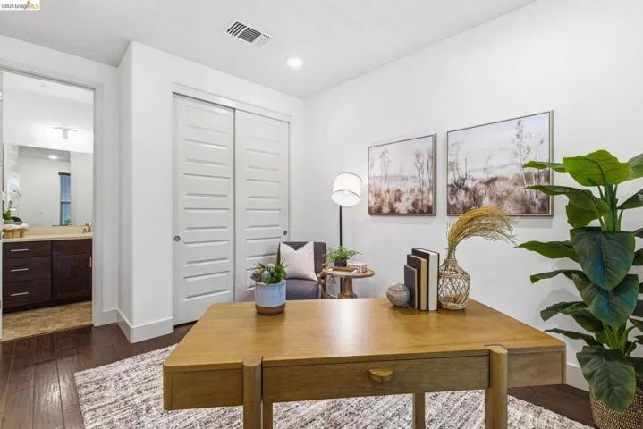 Home office featuring dark wood-style flooring and recessed lighting