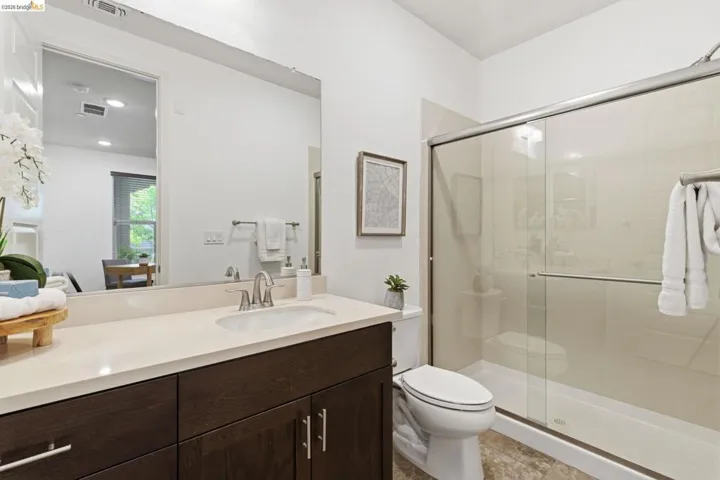 Bathroom featuring vanity and a shower stall