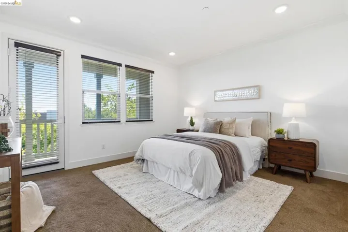 Bedroom featuring dark colored carpet, access to exterior, crown molding, and recessed lighting