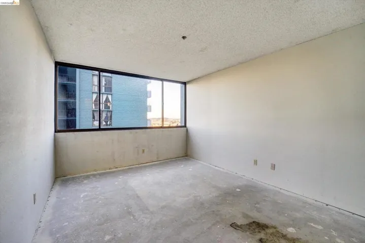 Unfurnished room featuring concrete floors and a textured ceiling