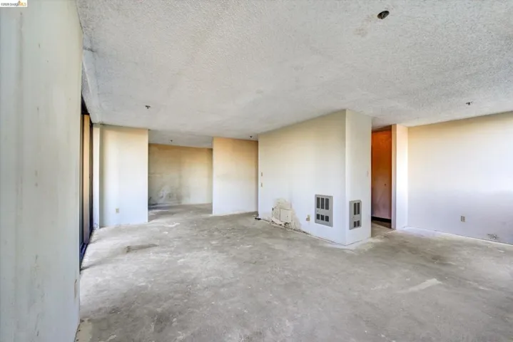 Unfurnished room featuring concrete flooring and a textured ceiling