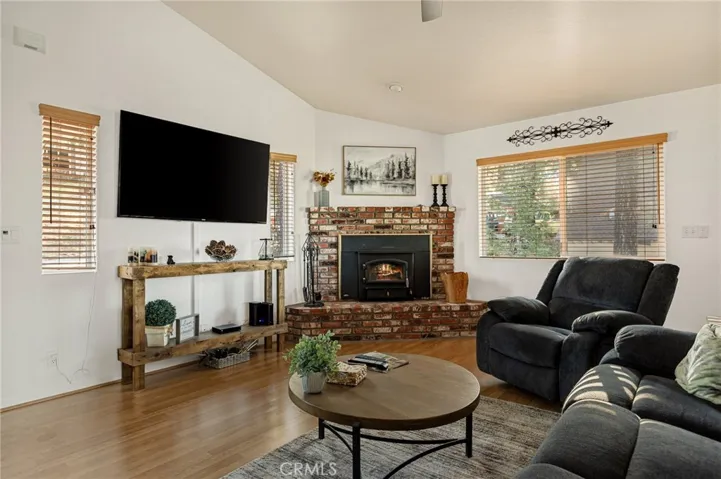 Enter into living room with fireplace open to kitchen and dining.